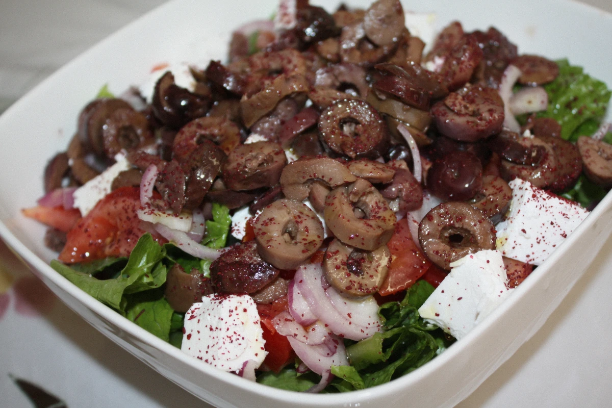 A Greek meze plate with feta, olives and tomatoes served on a Santorini boat tour, Greece