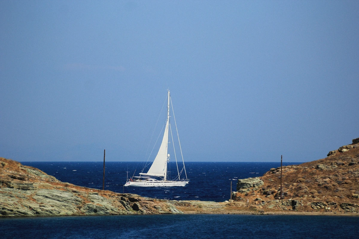 A private sailing yacht cutting through blue Cycladic water on a Santorini private boat charter, Greece